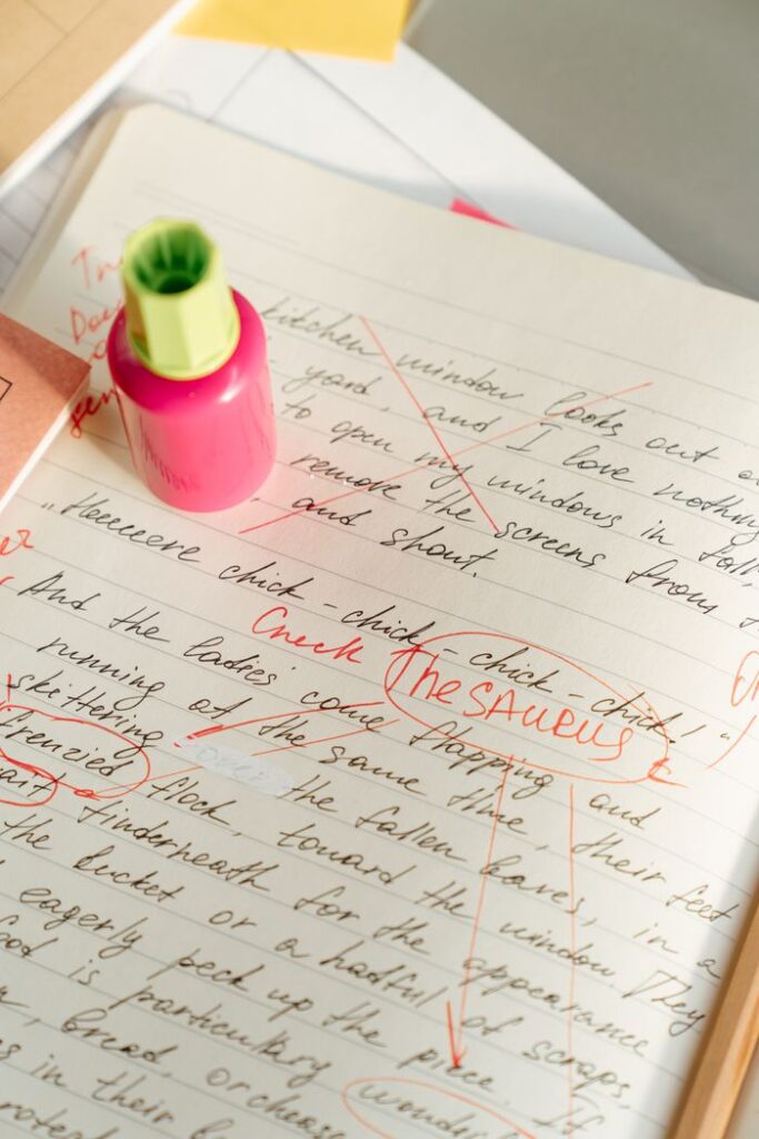 pexels photo 5185084 Vertical shot of a notebook with text edits and a highlighter, perfect for educational themes.
